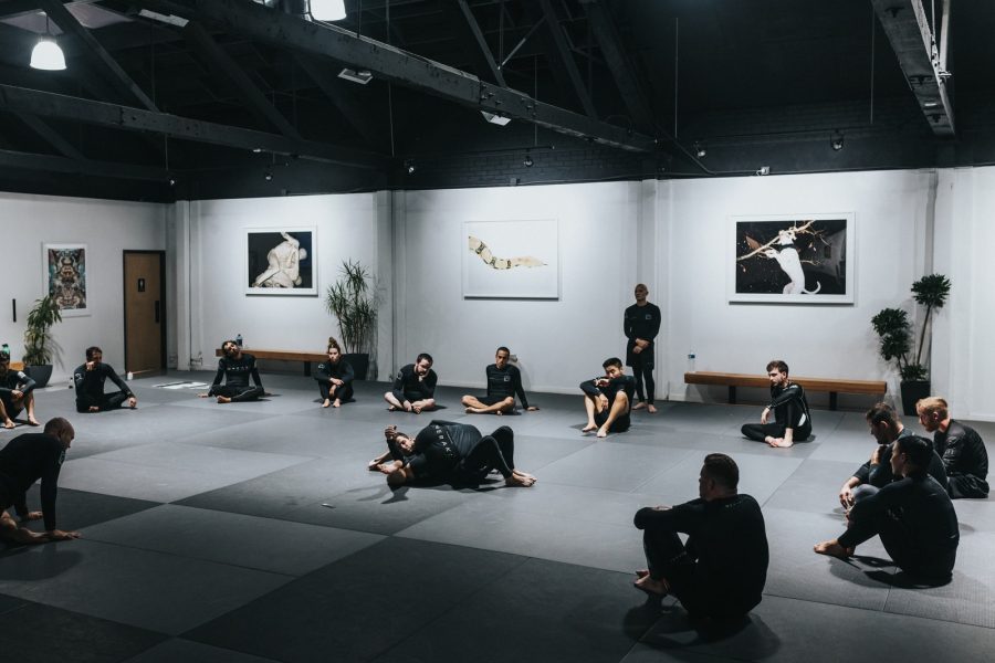 people sitting on floor in front of white wall